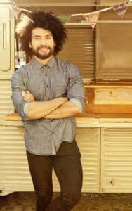 Man Standing Near Food Truck Smiling - Dental Crowns Tamatha L Johnson Brentwood Dental Designs New Hampshire