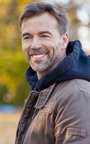 Older New Hampshire man shows off his dentures in Exeter, NH.