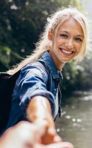 Smiling Young Woman Reaching Out - Teeth Whitening Tamatha L Johnson Brentwood Dental Designs New Hampshire