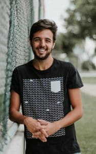 Young Man Leaning on Fence After Laser Dentistry in Exeter - Tamatha L Johnson Brentwood Dental Designs New Hampshire